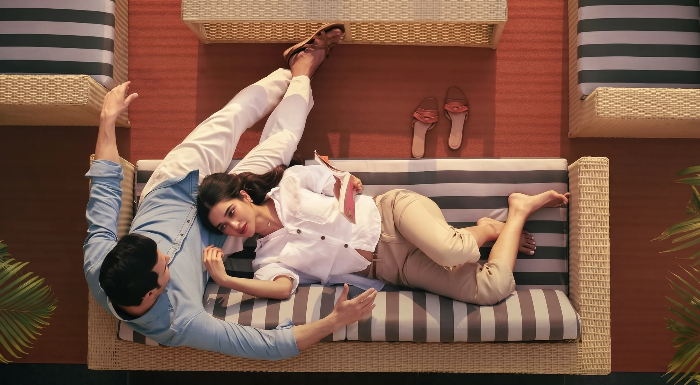 Couple relaxing on a sofa in a modern low-rise residence deck space at The Valley Orchard by DLF Panchkula